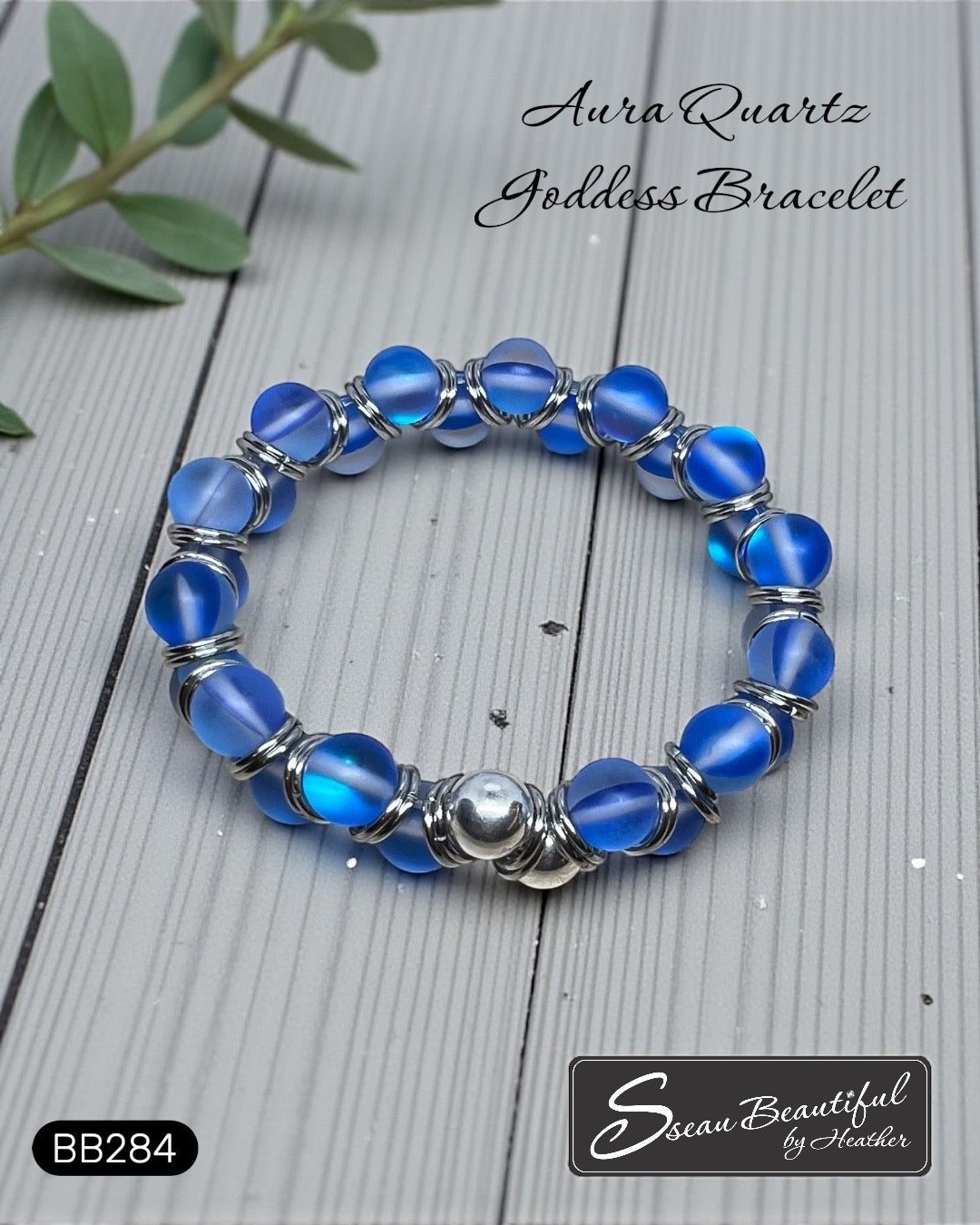 Blue beaded bracelet with silver accents on a wooden surface, featuring the brand 'Sseau Beautiful by Heather'.