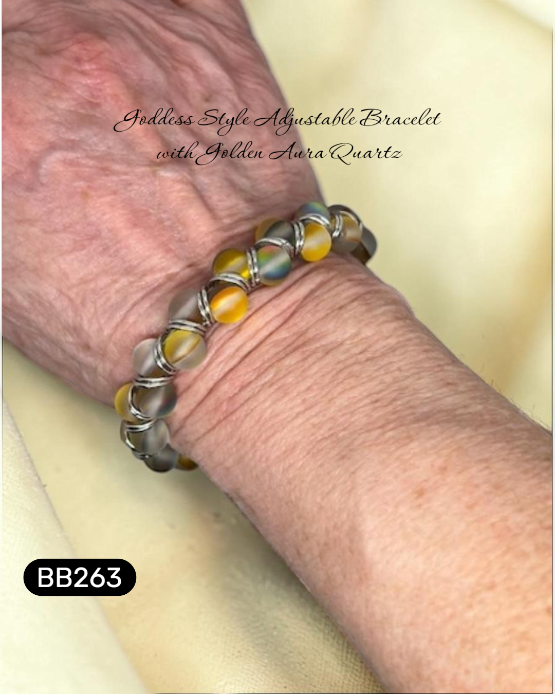 Bracelet with yellow and grey luminescent beads on a wrist, labeled 'Goddess Style Adjustable Bracelet with Golden Aura Quartz'.