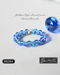 Blue beaded bracelet with silver accents on a light gray background, featuring the brand 'Sseau Beautiful by Heather'.