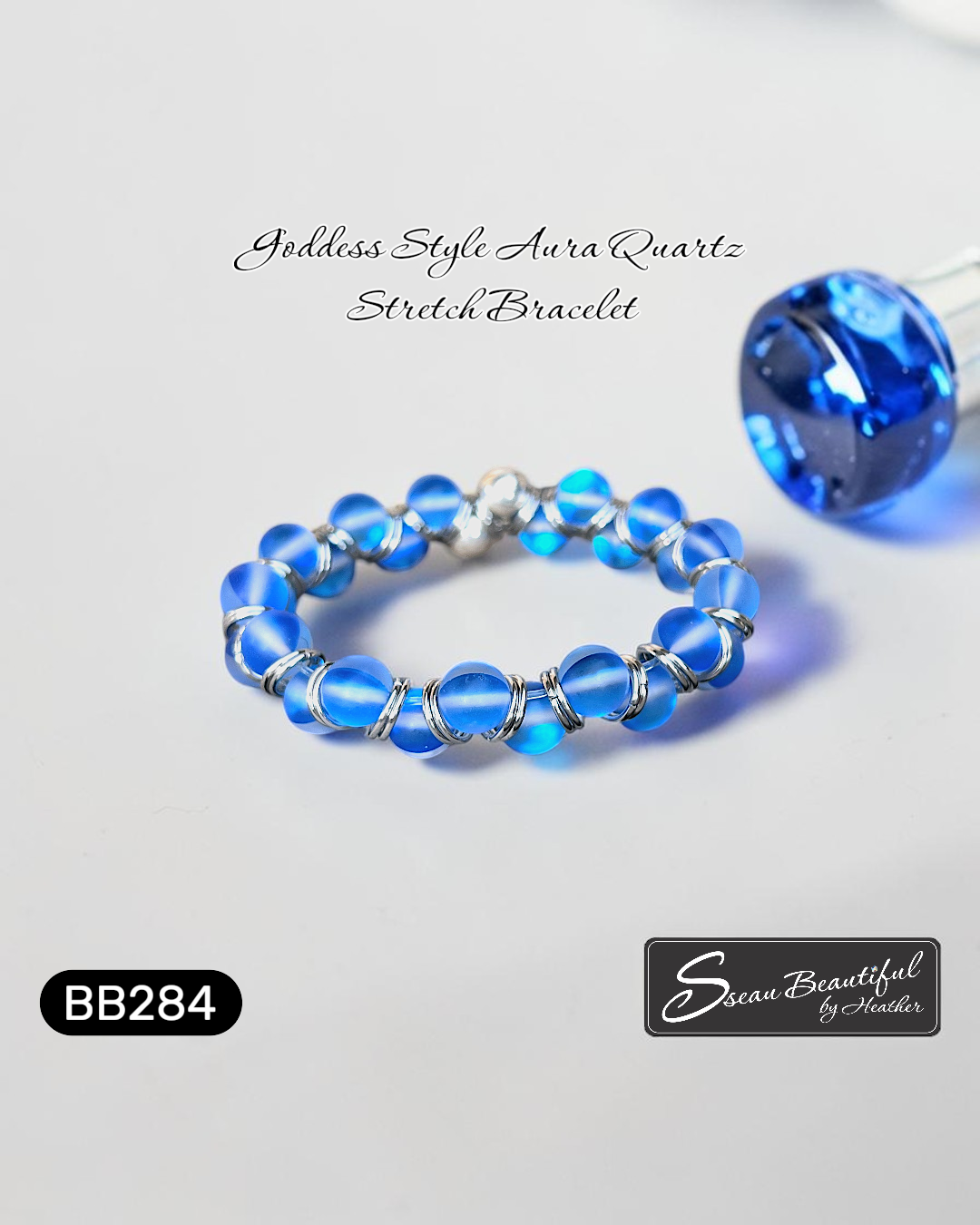 Blue beaded bracelet with silver accents on a light gray background, featuring the brand 'Sseau Beautiful by Heather'.