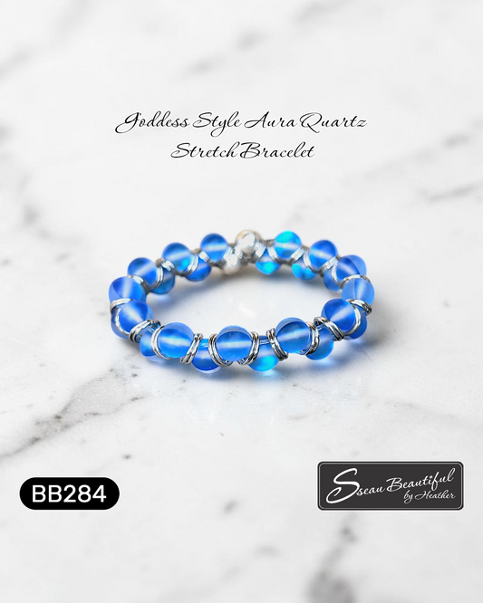 Goddess style blue stretch bracelet on a marble surface with 'Sseau Beautiful' branding.