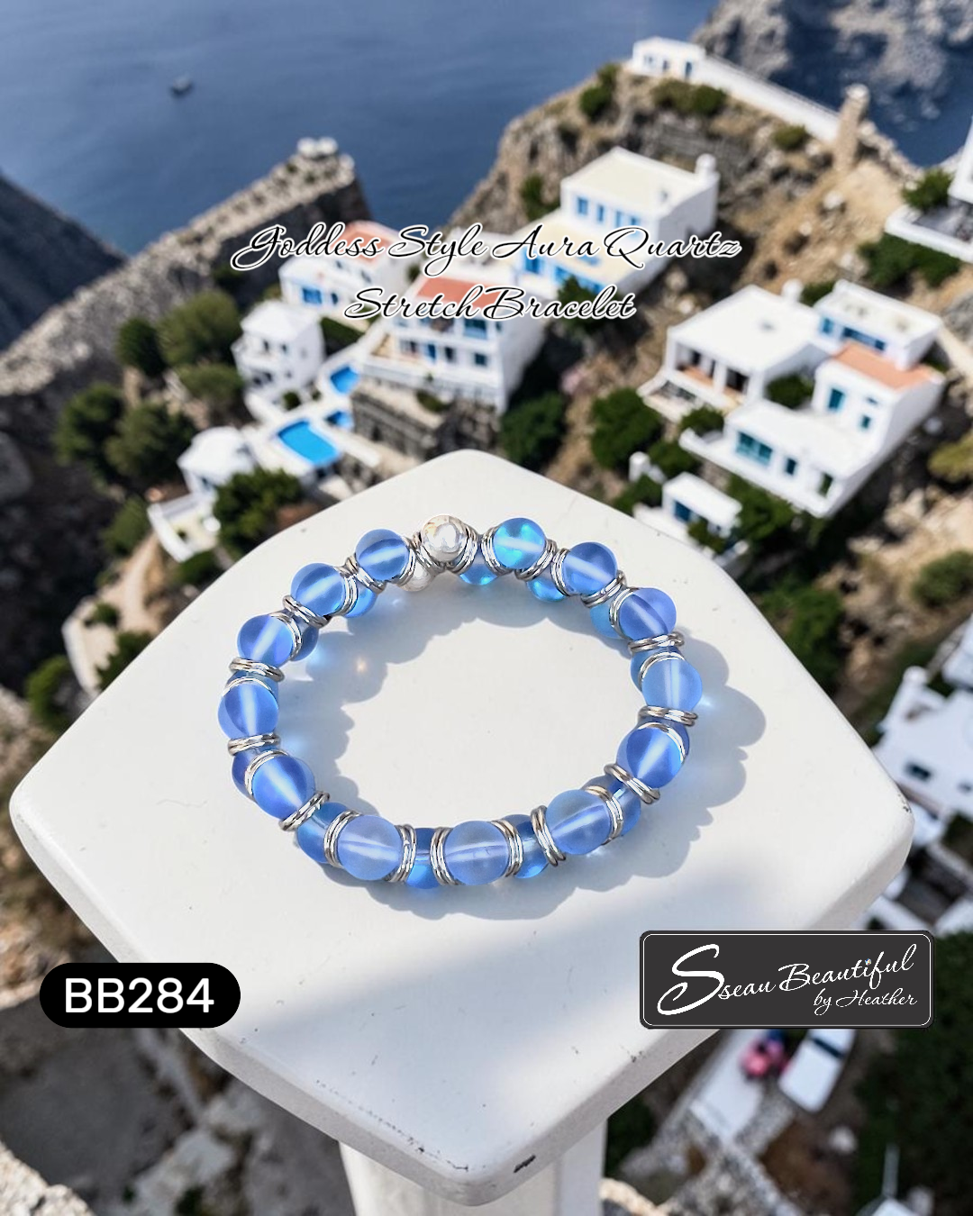 Blue beaded bracelet on a white pedestal with a scenic background