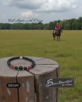 Bracelet on a wooden stump with a person riding a horse in a field, featuring 'Sseau Beautiful by Heather' branding.