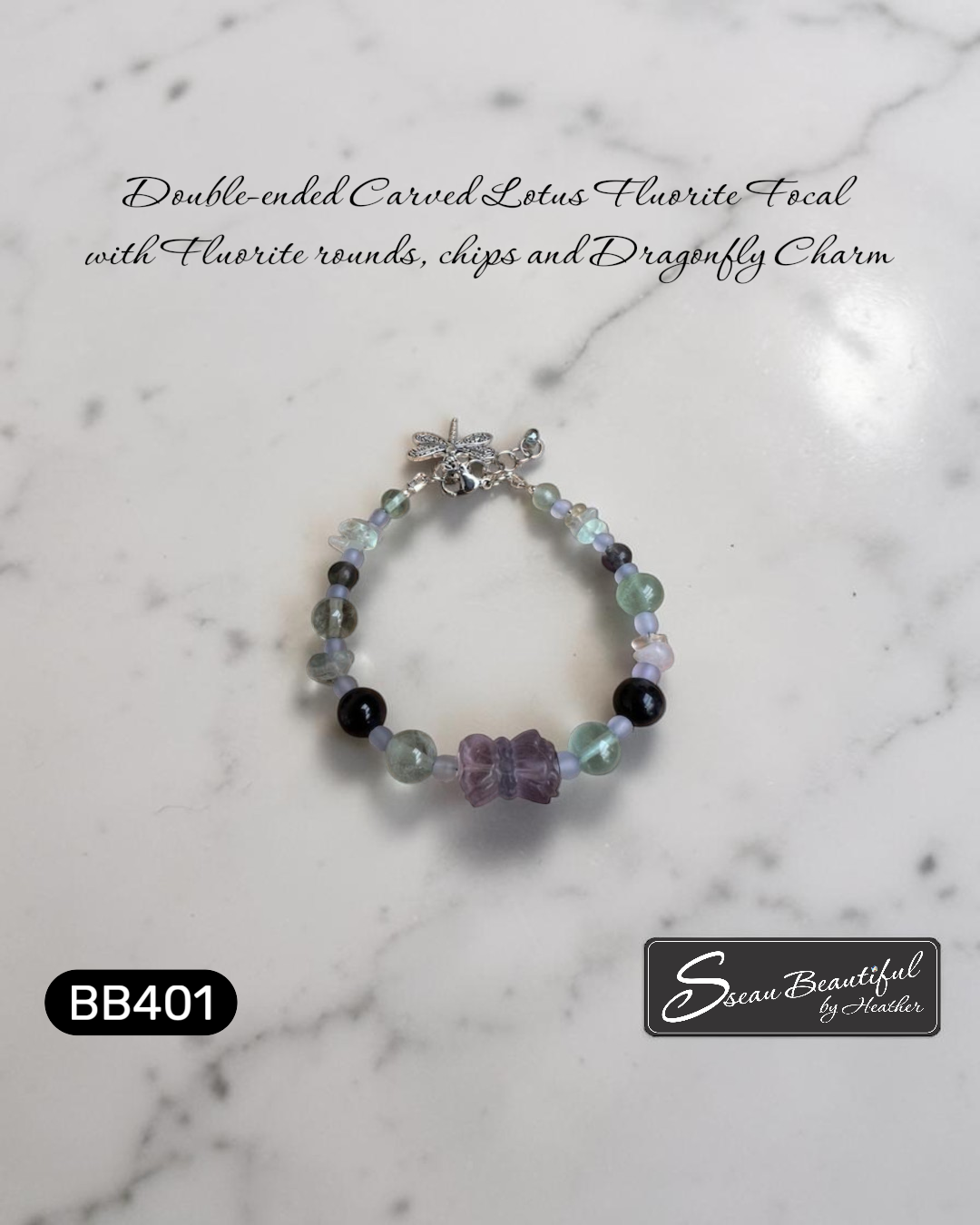 Photo of an adjustable bracelet strung with Fluorite round and chip beads featuring a double-ended carved Lotus Fluorite focal with a lobster clasp, extender, and a dragonfly charm, on a textured surface with descriptive text, "Sseau Beautiful" logo and model number