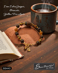 Adjustable bracelet with Iron Zebra Jasper, Bronzite, and Yellow Fire Agate stone beads on a table