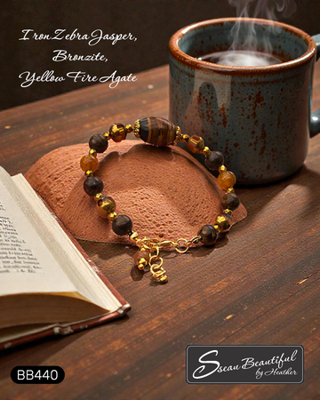 Adjustable bracelet with Iron Zebra Jasper, Bronzite, and Yellow Fire Agate stone beads on a table