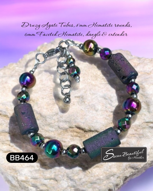 Adjustable Bracelet with Druzy Agate tubes and Hematite beads on a rock with purple background