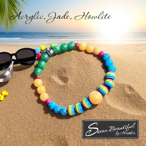 Colorful beaded necklace on sand with sunglasses and palm leaves, 'Sseau Beautiful' brand visible