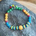 Colorful beaded bracelet on a dark stone surface