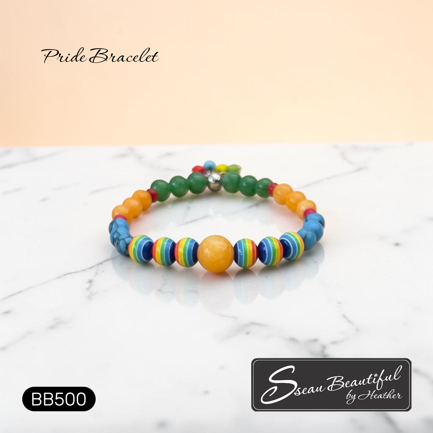 Colorful beaded bracelet on a marble surface with 'Sseau Beautiful by Heather' branding.