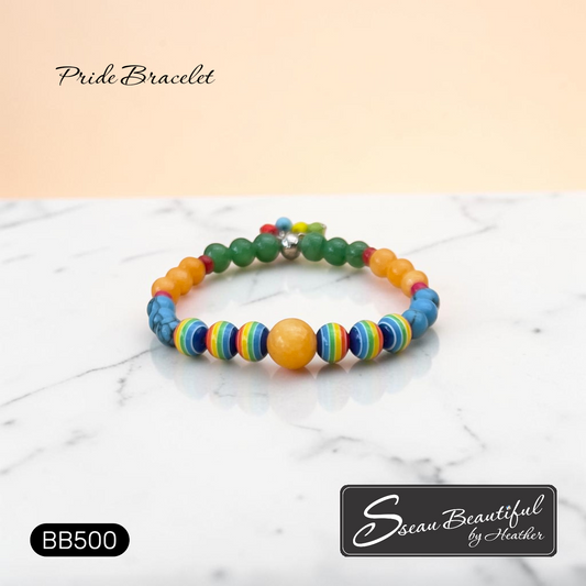 Colorful beaded bracelet on a marble surface with 'Sseau Beautiful by Heather' branding.