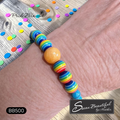 Colorful Pride Rainbow striped bracelet on a wrist with 'Sseau Beautiful' branding.