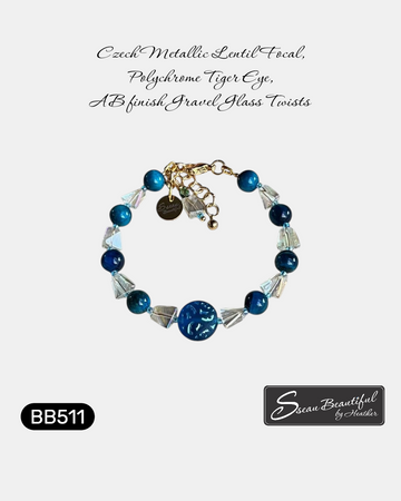 Adjustable 6.69 inch bracelet with a Czech Glass focal, Blue Tiger Eye rounds, AB finished Glass Nuggets, matching dangle, and a Stainless Steel Lobster Clasp and Extender 