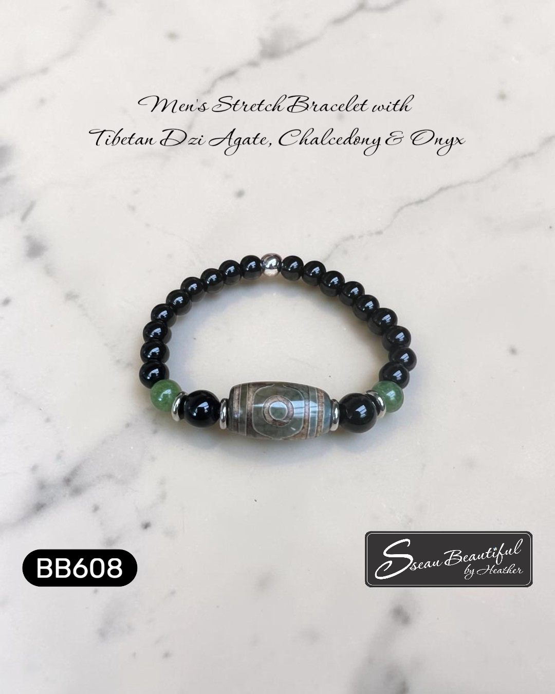 Men's stretch bracelet with Tibetan Dzi Agate, Chalcedony, and Onyx on a marble background.