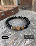 Black beaded bracelet with brown beads and silver accents, on a wooden surface, featuring 'Sseau Beautiful' branding.