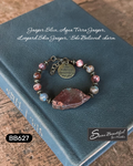 Adjustable bracelet with a large stone slice focal, with stone beads and metal spacers, and a charm with the text 