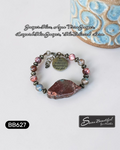 Adjustable bracelet with a large stone slice focal, with stone beads and metal spacers, and a charm with the text 