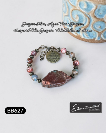Adjustable bracelet with a large stone slice focal, with stone beads and metal spacers, and a charm with the text "she believed she could so she did" on a white background