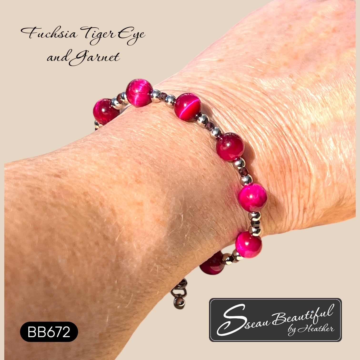 A close-up of a person's wrist wearing a beaded bracelet with bright fuchsia tiger eye and garnet beads separated by small silver stainless steel spacer beads. Text overlays read 'Fuchsia Tiger Eye and Garnet' and 'Sseau Beautiful by Heather', with a style code 'BB672'.