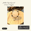 A beaded bracelet displayed on a clear stand over a round wooden tray, with the text 'Golden Tiger Eye and Citrine Nuggets' above and a logo at the bottom right reading 'Sseau Beautiful by Heather'.