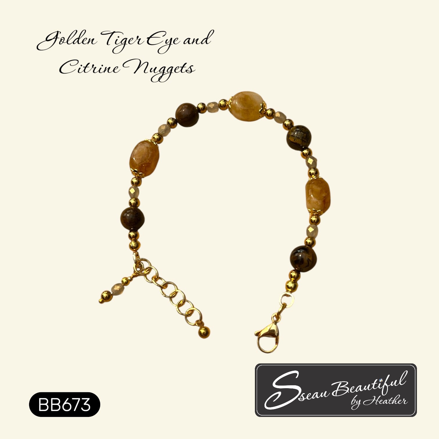 A beaded bracelet with golden tiger eye and citrine nuggets and gold-toned stainless steel beads, displayed on a cream background with brand text 'Sseau Beautiful by Heather' and style code 'BB673'.