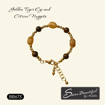 A beaded bracelet with golden tiger eye and citrine nuggets, featuring gold-toned stainless steel beads and a clasp, displayed on a cream background with text overlays.
