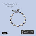 A freshwater pearl and lapis lazuli bracelet displayed on a light blue background, featuring white baroque pearls, deep blue lapis beads, and a stainless steel clasp. Text overlays include 'Fresh Water Pearls and Lapis' at the top, 'BB671' in a black box at the bottom left, and a logo for 'Sseau Beautiful by Heather' at the bottom right.