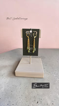 Green beaded and chain earrings on a display light colour background Text showing B.C. Jade earrings with Sseau Beautiful Logo