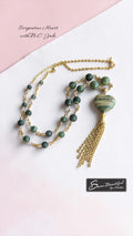 Green beaded and chain Necklace on a light colour background Text showing Serpentine Heart with B.C. Jade  and a Sseau Beautiful Logo