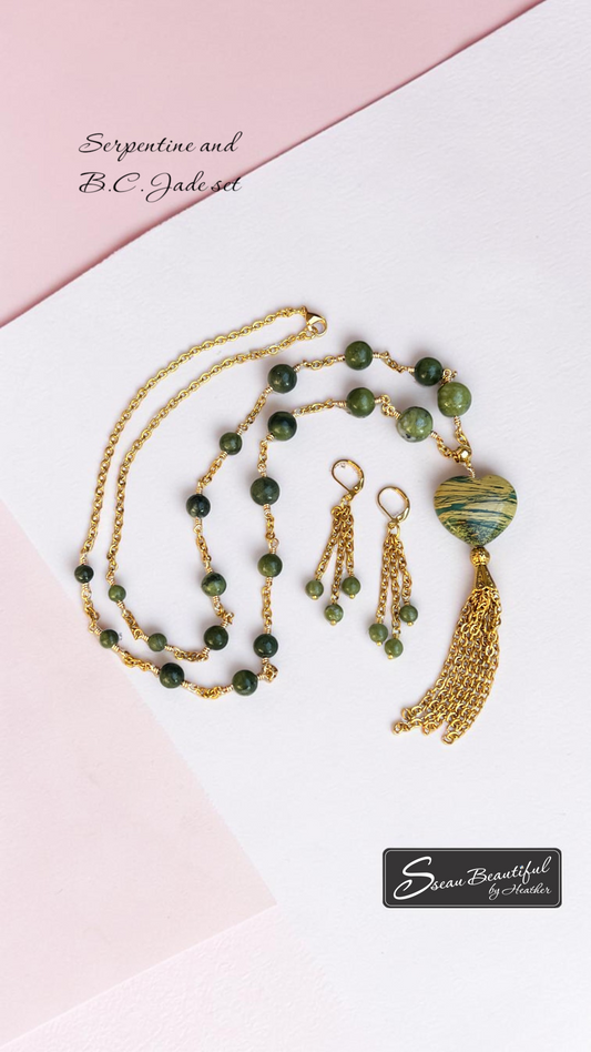 Green beaded and chain Necklace and earrings on a light colour background Text showing Serpentine and B.C. Jade set with Sseau Beautiful Logo