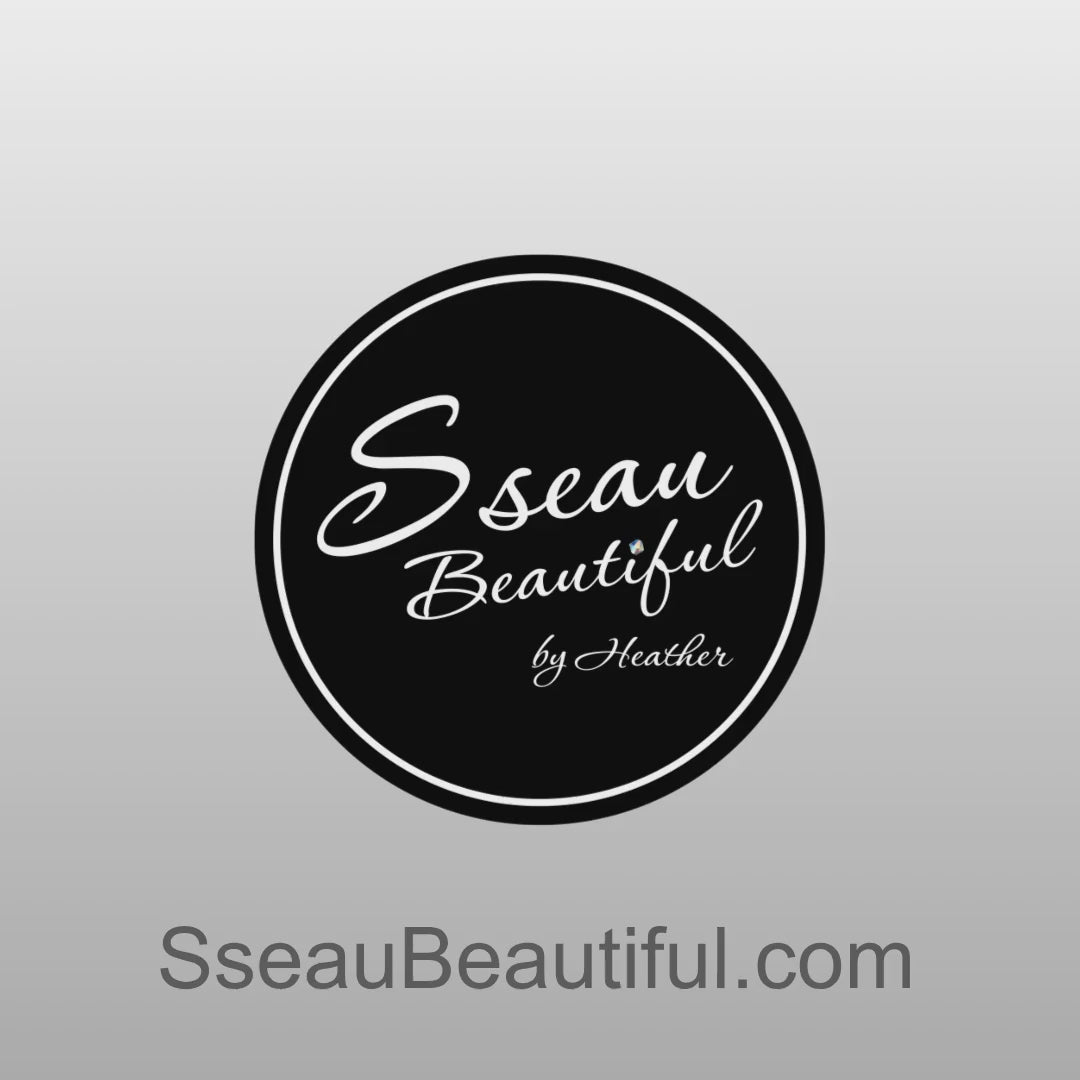 A bracelet made from Yellow and Grey Aura Quartz on a turning stand with the Sseau Beautiful logo and website at the end