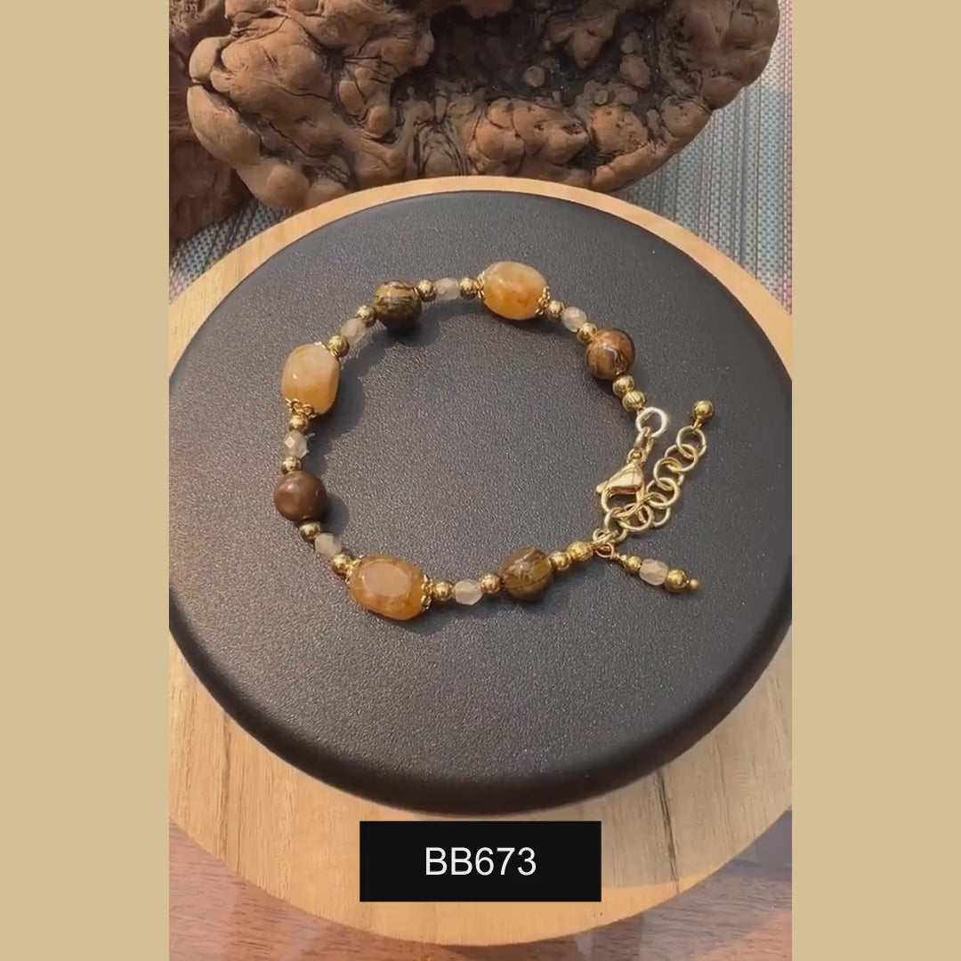 Golden Tiger Eye bracelet with Citrine and Czech Fire Polish crystals on a rotating display.