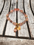 Sseau Beautiful! Strawberry Dream stretch bracelet with rose quartz, strawberry quartz, Czech crystals, gold bead caps, butterfly charm, and pink teardrop dangle.