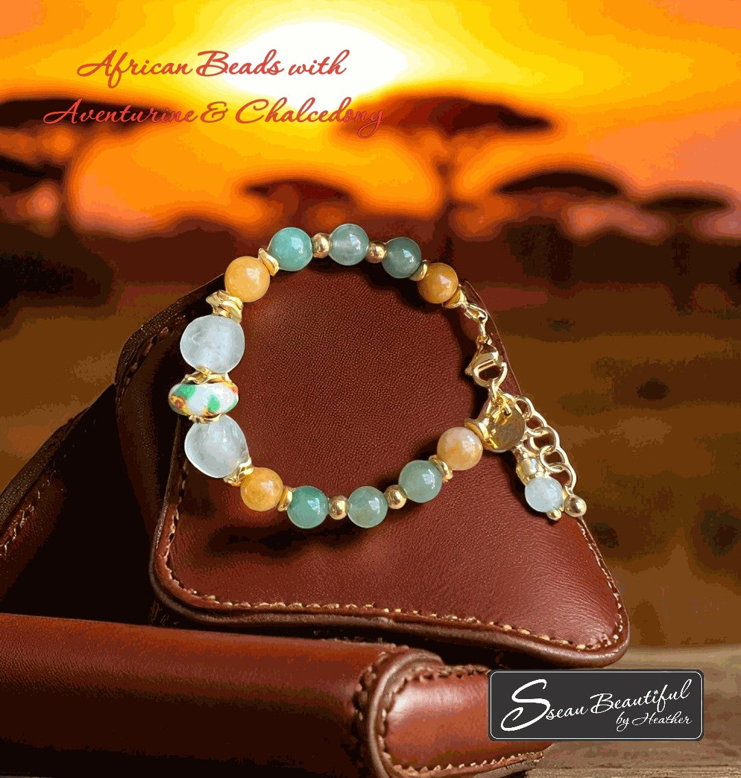 Sseau Beautiful adjustable bracelet with green aventurine, orange chalcedony, and African beads on a brown leather pouch.