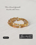 Sseau Beautiful! warm gold three-strand adjustable bracelet with citrine beads and faceted glass accents.