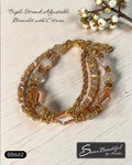 Sseau Beautiful! warm gold triple strand bracelet with citrine beads and faceted glass accents. Adjustable.