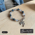 Sseau Beautiful! adjustable bracelet with dark blue Howlite, Aquamarine beads, and filigree heart charm.