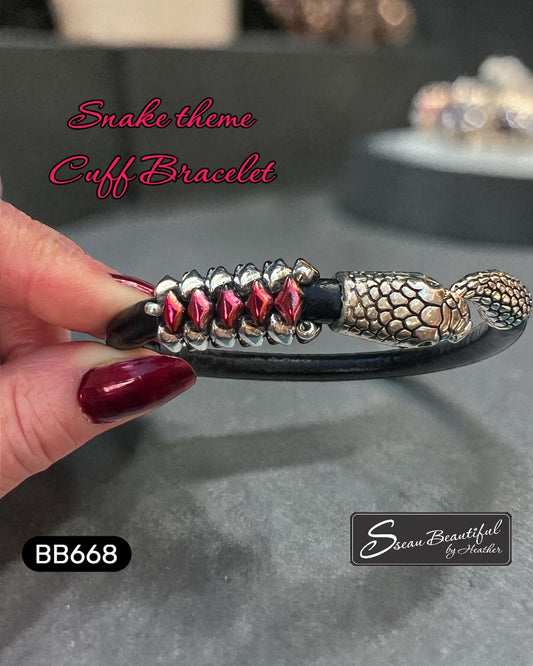 Sseau Beautiful! black leather cuff bracelet with snake head clasp and red Matubo GemDuo beads.
