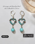 Sseau Beautiful! turquoise heart dangle earrings with floral accents and stainless steel lever backs.